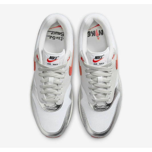 White Nike Air Max sneakers with red accents on a white background