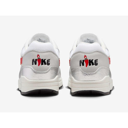 White sneakers with red and black Nike logo on a white background