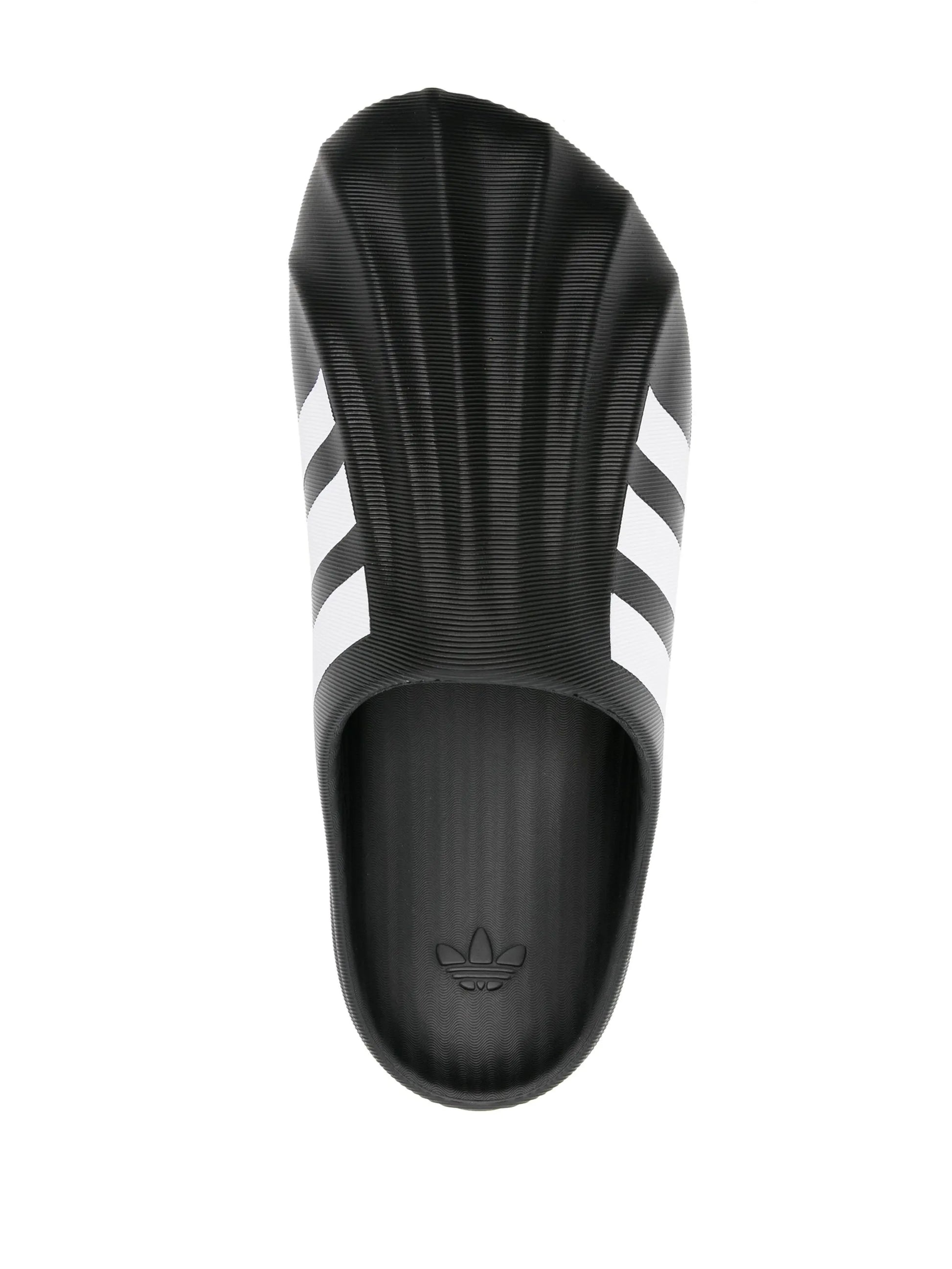 Black Adidas slide sandal with three white stripes on a white background