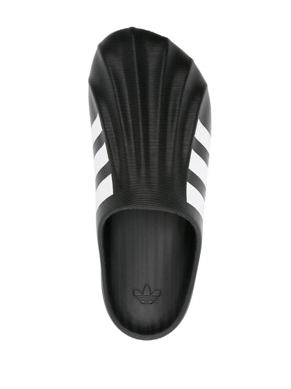 Black Adidas slide sandal with three white stripes on a white background