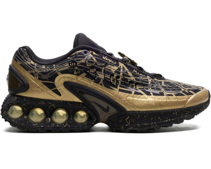 Black and gold sneaker with unique sole design on a white background