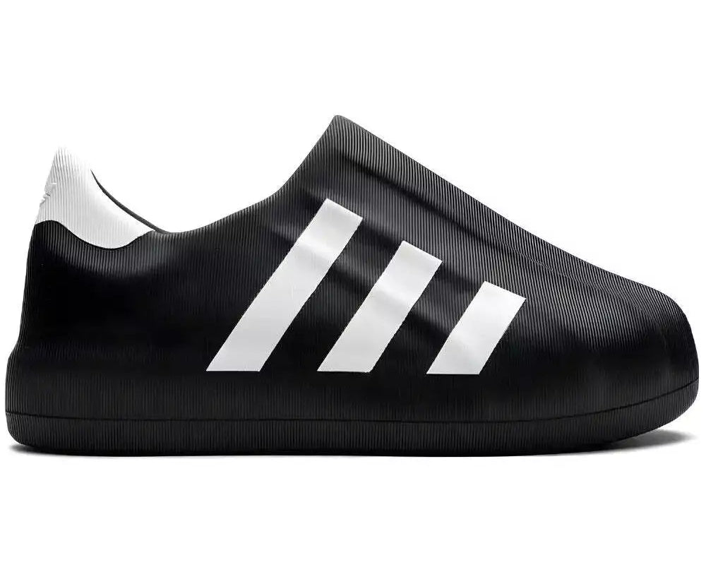 Black Adidas shoe with white stripes on a white background